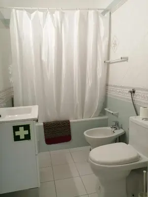 a white bathroom with a toilet and a sink at Oura Villa V5 in Albufeira