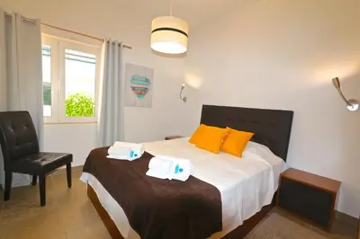 a bedroom with a bed with towels on it at Neptuno 97 - Clever Details in Vilamoura