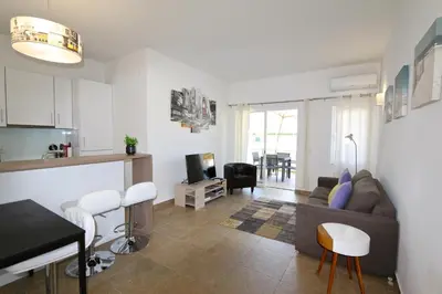 a living room with a couch and a table at Neptuno 97 - Clever Details in Vilamoura