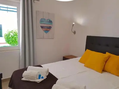 a bedroom with a bed with two towels on it at Neptuno 97 - Clever Details in Vilamoura