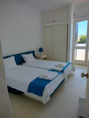 a bedroom with two beds and a large window at Dreamly Sea in Albufeira