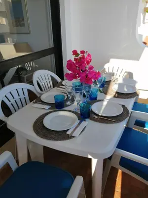 a white table with plates and flowers on it at Dreamly Sea in Albufeira