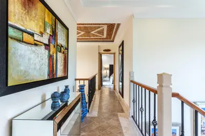 a hallway of a house with a painting on the wall at Villa Maureena - Quinta do Mar in Almancil