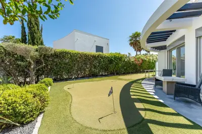 a golf course in the yard of a house at Villa Croesa - Vale de Lobo in Almancil