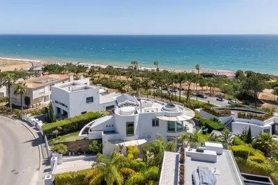 an aerial view of a house and the beach at Villa Croesa - Vale de Lobo in Almancil