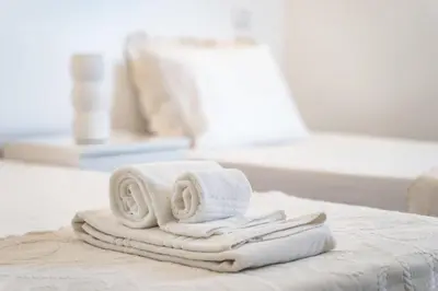a pile of towels sitting on top of a bed at Vilamoura Marina Apartment with swimming pool in Vilamoura
