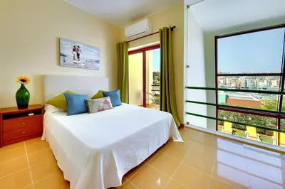 a bedroom with a bed and a large window at Vila Marina -BBQ, pool & garden- by Seareen in Albufeira