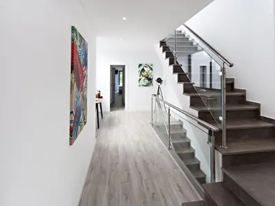 a staircase in a white house with wooden floors and a stair case at Faro Clara Suites in Faro