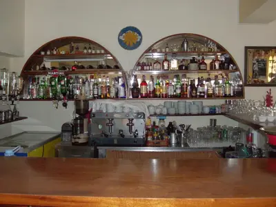 a bar with a lot of bottles of alcohol at Sunshine in Albufeira