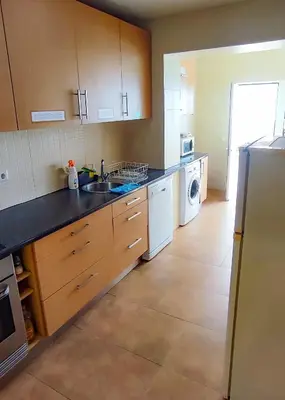 a kitchen with a sink and a dishwasher at Surf Vibe Guest House in Faro