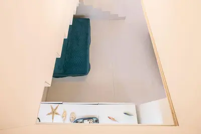 a shelf with a green vase and other items on a wall at LovelyStay - Two Bedroom Duplex at Vilamoura Marina in Vilamoura