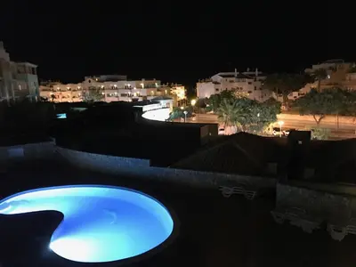 a blue hot tub on a roof at night at SOMAR Torre de Medronheira OLHOS DE AGUA ALBUFEIRA in Olhos de Água