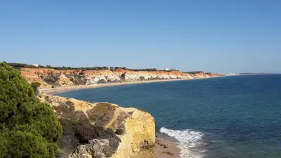 a view of a beach with rocks and the ocean at SOMAR Torre de Medronheira OLHOS DE AGUA ALBUFEIRA in Olhos de Água