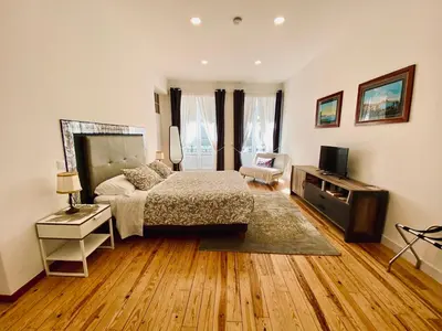 a bedroom with a bed and a television in it at Casa Saudade luxury rooms in Faro