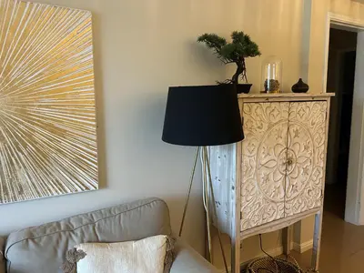 a living room with a couch and a lamp at Dream House - Condominio com piscina aquecida e propriedade com 5 bicicletas incluindo 1 eletrica in Albufeira
