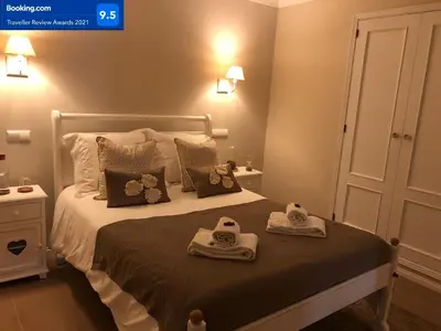 a bedroom with a bed with towels on it at Dream House - Condominio com piscina aquecida e propriedade com 5 bicicletas incluindo 1 eletrica in Albufeira