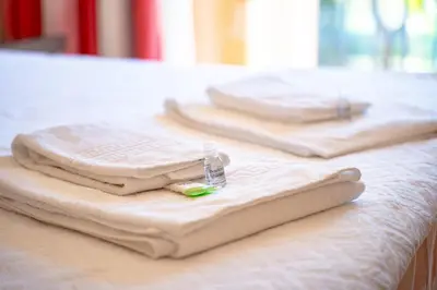 two folded towels sitting on top of a table at AL - Apartamento Vila Sol F5 AH in Quarteira