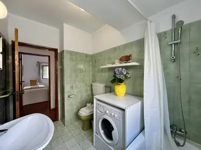 a small room with two beds and a window at Vilamoura Ocean Villa with Pool by Homing in Vilamoura
