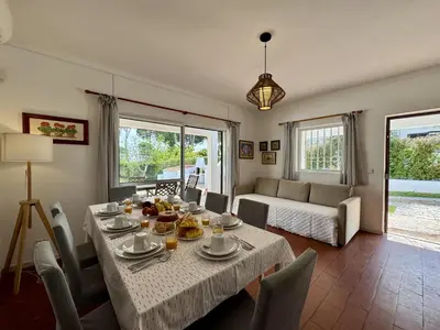 a table with a yellow umbrella and food on it at Vilamoura Ocean Villa with Pool by Homing in Vilamoura