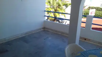 a room with a balcony with a table and a chair at Oura Li in Albufeira