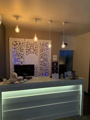 a dining room with a table and a white couch at Aqua Ria Boutique Hotel in Faro
