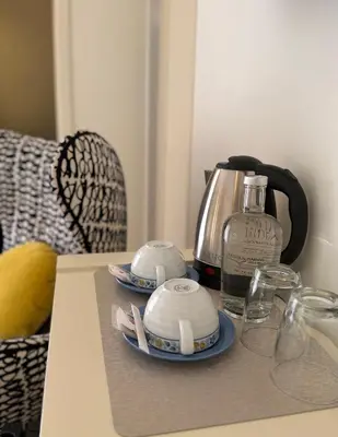 a room with a desk with a lamp and a chair at Aqua Ria Boutique Hotel in Faro