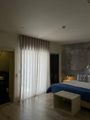 a yellow pillow on a black and white chair at Aqua Ria Boutique Hotel in Faro