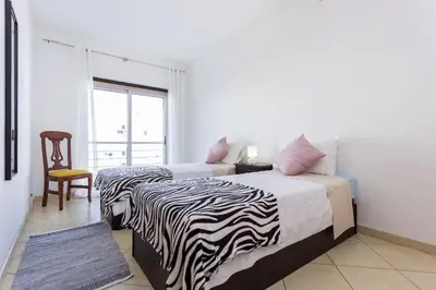 two beds in a room with a zebra blanket at Cozy apartment in Albufeira 76 m² with lovely terrace in Albufeira