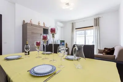 a dining room table with wine glasses on it at Cozy apartment in Albufeira 76 m² with lovely terrace in Albufeira