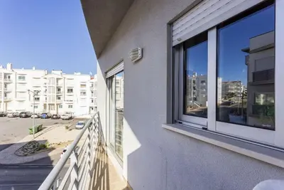 a balcony of a building with a view of a street at Cozy apartment in Albufeira 76 m² with lovely terrace in Albufeira