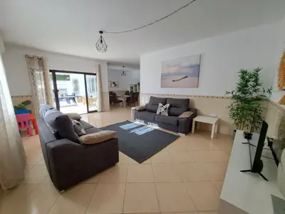 a living room with two couches and a television at Villa Claramar in Albufeira