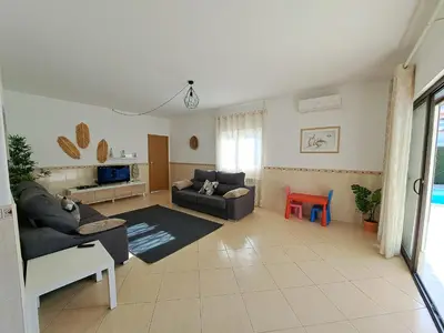 a living room with a couch and a table at Villa Claramar in Albufeira