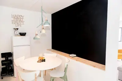 a white dining room with a white table and chairs at Casa Olga Vieira in Albufeira