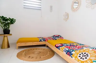 two twin beds in a room with a rug at Casa Olga Vieira in Albufeira