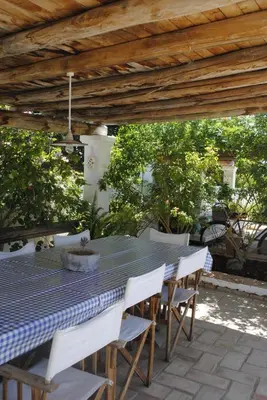 a blue table and chairs under a wooden pergola at Monte das Cortelhas in Guia