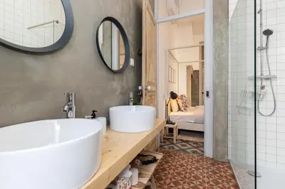 a bathroom with a large tub and a sink at aleixomor'Aqui in Loulé