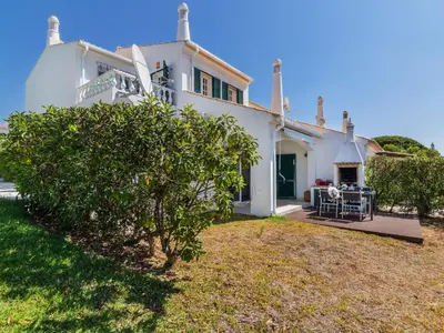 a white house with a tree in front of it at Holiday Home Roberts by Interhome in Albufeira