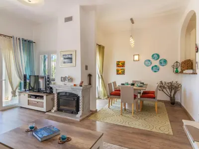a living room with a table and a living room with a tv at Holiday Home Roberts by Interhome in Albufeira