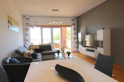 a living room with a couch and a table with chairs at Golf Mar Village By Vilamoura Sun- Vista Golfe in Vilamoura