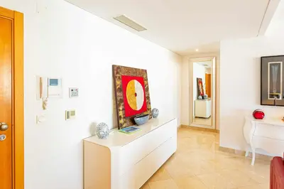 a living room with white walls and a painting on the wall at Walkable Marina Vilamoura Aquamar 513 VilamouraSun in Quarteira