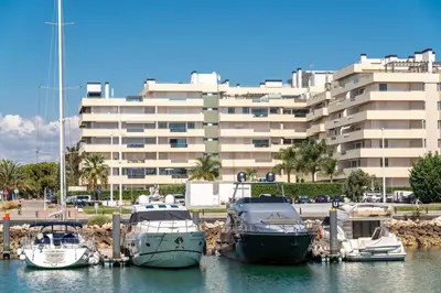 a group of boats docked in a harbor with a building at Walkable Marina Vilamoura Aquamar 513 VilamouraSun in Quarteira