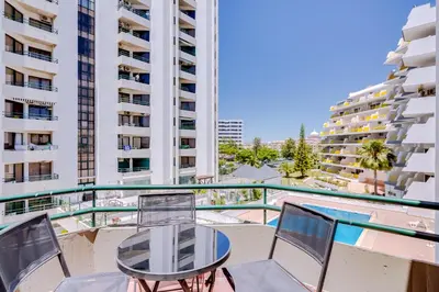 a balcony with a table and chairs and buildings at Algamar Apartment - Vilamoura Center in Vilamoura