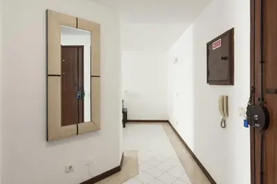 a hallway with a mirror and a door at Algamar Apartment - Vilamoura Center in Vilamoura