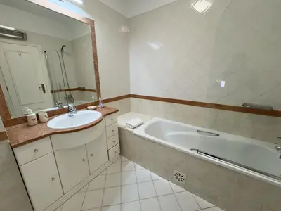 a bathroom with a tub and a sink and a mirror at Vilamoura Center - Near Marina By Vilamoura Sun in Quarteira