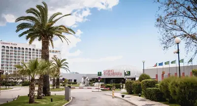 a palm tree in front of a hotel at Vilamoura Center - Near Marina By Vilamoura Sun in Quarteira