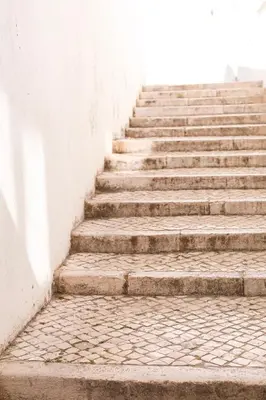 a set of concrete stairs next to a wall at Peneco Albufeira GuestHouse in Albufeira