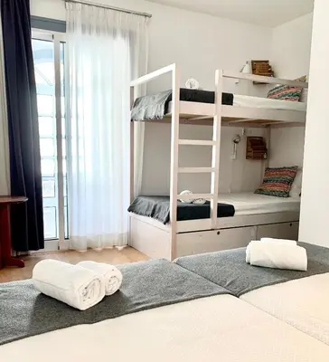 a bedroom with bunk beds with towels on the floor at Peneco Albufeira GuestHouse in Albufeira