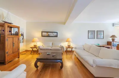 a living room with a white couch and a coffee table at Apartamento dentro da Marina de Vilamoura in Vilamoura