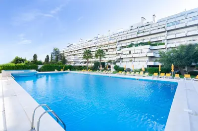 a large swimming pool in front of a building at Apartamento dentro da Marina de Vilamoura in Vilamoura