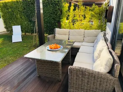 a patio with a couch and a table with oranges on it at Townhouse 3 Bedroom Townhouse Olhos de Agua Communal pool AT03 in Olhos de Água